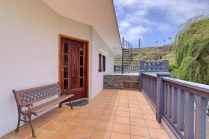 a bench on the balcony of a house at VV La Karajita in Mazo
