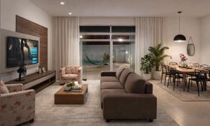 a living room with a couch and a table at Casa 3km da praia com piscina, 3 quartos, 2 km das praia do Aracagir in São Luís