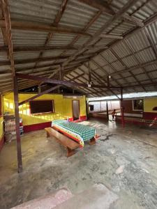 a large room with a table and a bench in it at Quarto Ilha do amor in Santarém