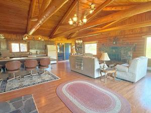 a large living room with a kitchen and a fireplace at 12 Mile Ranch in Custer