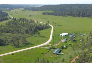 an aerial view of a farm with a road at 12 Mile Ranch in Custer
