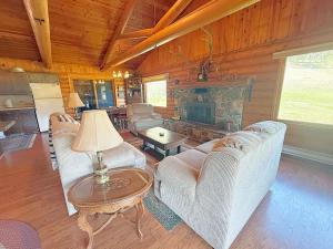a living room with couches and a fireplace in a cabin at 12 Mile Ranch in Custer