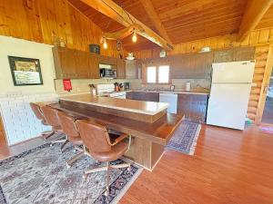 a large kitchen with a large table and a refrigerator at 12 Mile Ranch in Custer +20 photos
