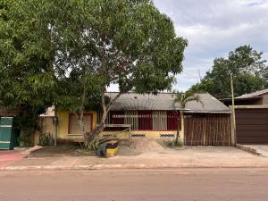 a building with a tree in front of a street at Quarto Ilha do amor in Santarém