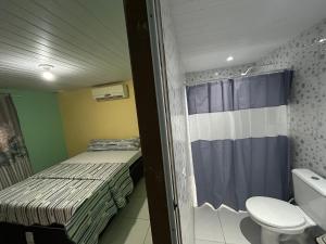 a small room with two beds and a toilet at Quarto Ilha do amor in Santarém +42 photos