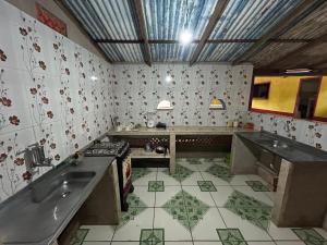 a kitchen with a sink and a counter top at Quarto Ilha do amor in Santarém
