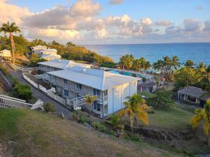 an aerial view of a house next to the ocean at Un petit joyau 215 in Le Diamant