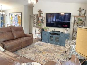 a living room with a couch and a flat screen tv at Battle Creek Station in Keystone