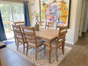 a wooden dining room table and chairs on a rug at Battle Creek Station in Keystone