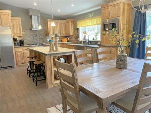 a large kitchen with a wooden table and chairs at Battle Creek Station in Keystone