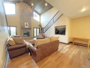 a living room with two couches and a tv at Bishop Mountain Lookout in Hill City