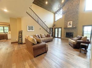 a large living room with two couches and a fireplace at Bishop Mountain Lookout in Hill City