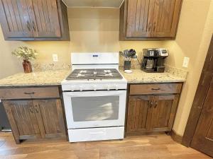 a kitchen with a stove and a counter top at Bishop Mountain Lookout in Hill City