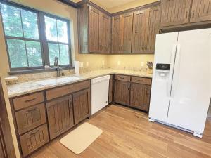 a kitchen with wooden cabinets and a white refrigerator at Bishop Mountain Lookout in Hill City +19 photos