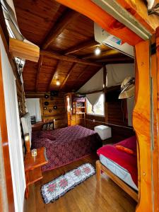 a bedroom in a boat with a bed in it at Amaneceres de San Isidro in José de la Quintana