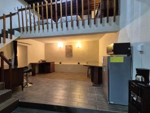 a large room with a staircase and a table and a refrigerator at Casa de Chacha in Guanajuato