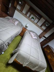 two twin beds in a room with at Casa de Chacha in Guanajuato