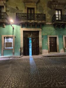 an old building with two doors on a street at Casa de Chacha in Guanajuato