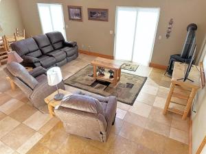a living room with a couch and a table at Cottage at Storm Mountain #3 in Hill City