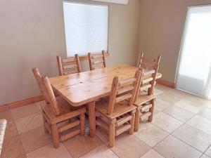 a wooden table and chairs in a room at Cottage at Storm Mountain #3 in Hill City +15 photos