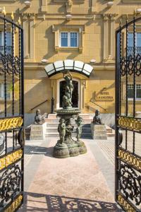 a gate with a fountain in front of a building at La Galería in San Sebastián