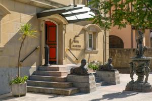 a building with stairs and statues in front of it at La Galería in Donostia-San Sebastián