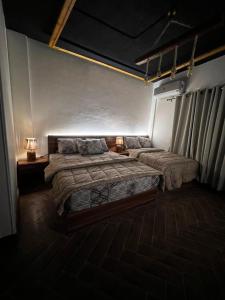 a bedroom with two beds and two lamps in it at 44 Inn in Dahab