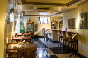 a restaurant with a bar and some tables and chairs at La Galería in Donostia-San Sebastián