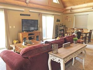 a living room with a couch and a table at Cottage at Storm Mountain #5 in Hill City