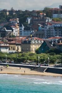 a view of a beach with a city in the background at La Galería in Donostia-San Sebastián