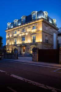 a large white building with lights on it at La Galería in Donostia-San Sebastián