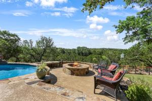 a patio with a table and chairs next to a pool at Canyon Lake Lighthouse in Canyon Lake