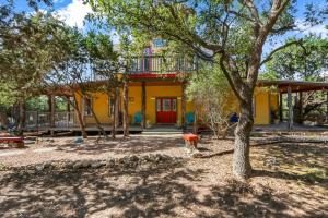 a yellow house with a tree in front of it at Canyon Lake Lighthouse in Canyon Lake +32 photos