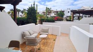 a patio with two chairs and a table at Iris 25 in Playa Blanca