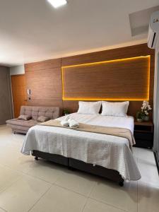 a bedroom with a large bed with a large headboard at Uruguaiana House in Uruguaiana