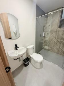 a bathroom with a toilet and a sink and a shower at Total Comfort Studio Santa Rosa in Santa Rosa de Cabal +43 photos