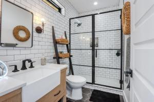a bathroom with a toilet and a glass shower at Canyon Tree House in Canyon Lake