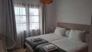 a bedroom with a bed with two towels on it at Iris 25 in Playa Blanca +10 photos
