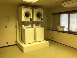 two refrigerators and a washer and dryer in a room at Hotel Crown Hills Kofu in Kofu