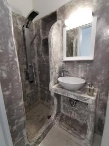 a bathroom with a sink and a shower at Meltemi Chora Amorgos in Amorgos