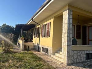 a yellow house with a fire hydrant in front of it at Villa Cà Bottura agli ulivi in Bardolino