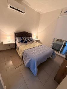 a bedroom with a bed and a window at La casa Azul in Acapulco +10 photos