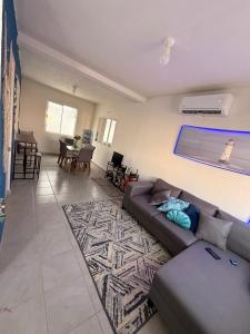 a living room with a couch and a rug at La casa Azul in Acapulco