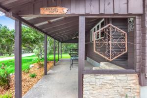 a pergola with a sign that says canyon west at Canyon Vista in Wimberley