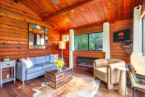 a living room with a couch and a chair at Canyon Vista in Wimberley +24 photos