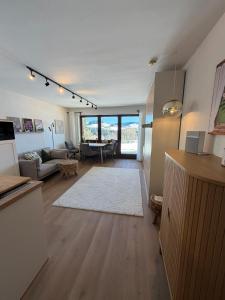 a living room with a couch and a table at Neu - Ferienwohnung Allgäuparadies - Traumhafte Aussichten mitten in der Natur des Westallgäus in Oberreute +20 photos