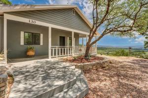 a house with a porch and a tree in front of it at Casa Cielo in Wimberley