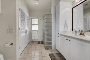 a white bathroom with a sink and a toilet at Casa Cielo in Wimberley