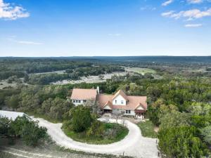 an aerial view of a house with a winding road at Casa Robles- The Bluebonnet in Wimberley