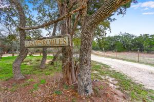 a sign that says castle rolls on a tree at Casa Robles- The Bluebonnet in Wimberley